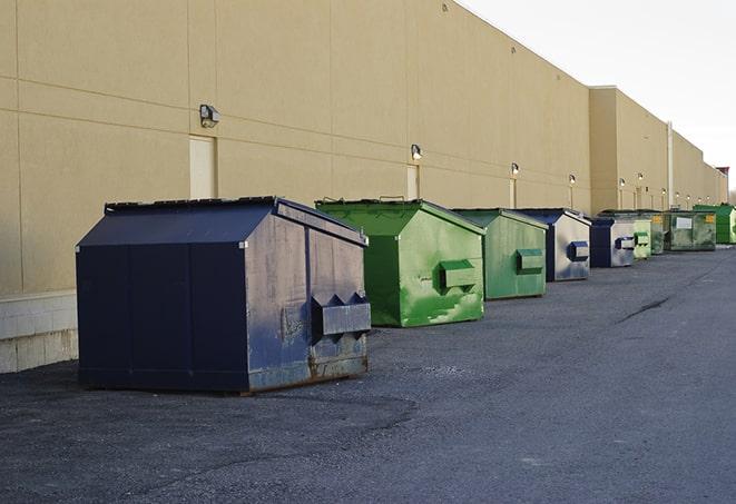 a group of construction workers taking a break near a dumpster in Barnegat